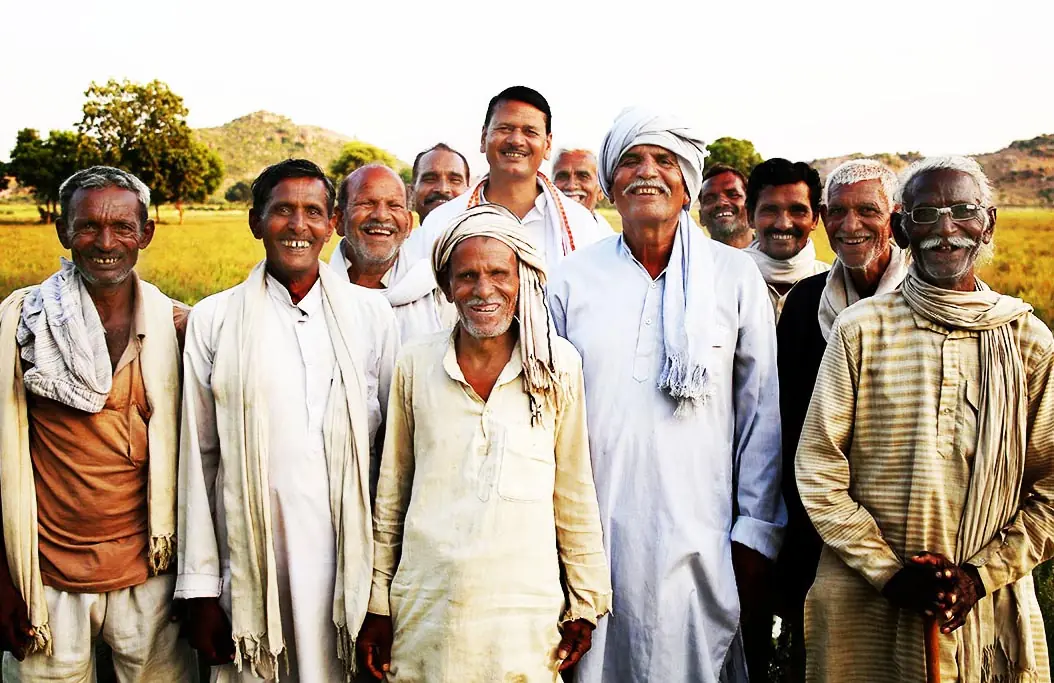 Group of farmers giving thumbs up in a field