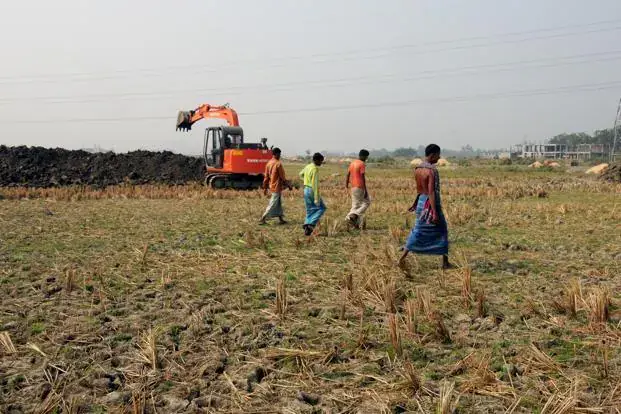 Farmer and vendor shaking hands for a land lease agreement